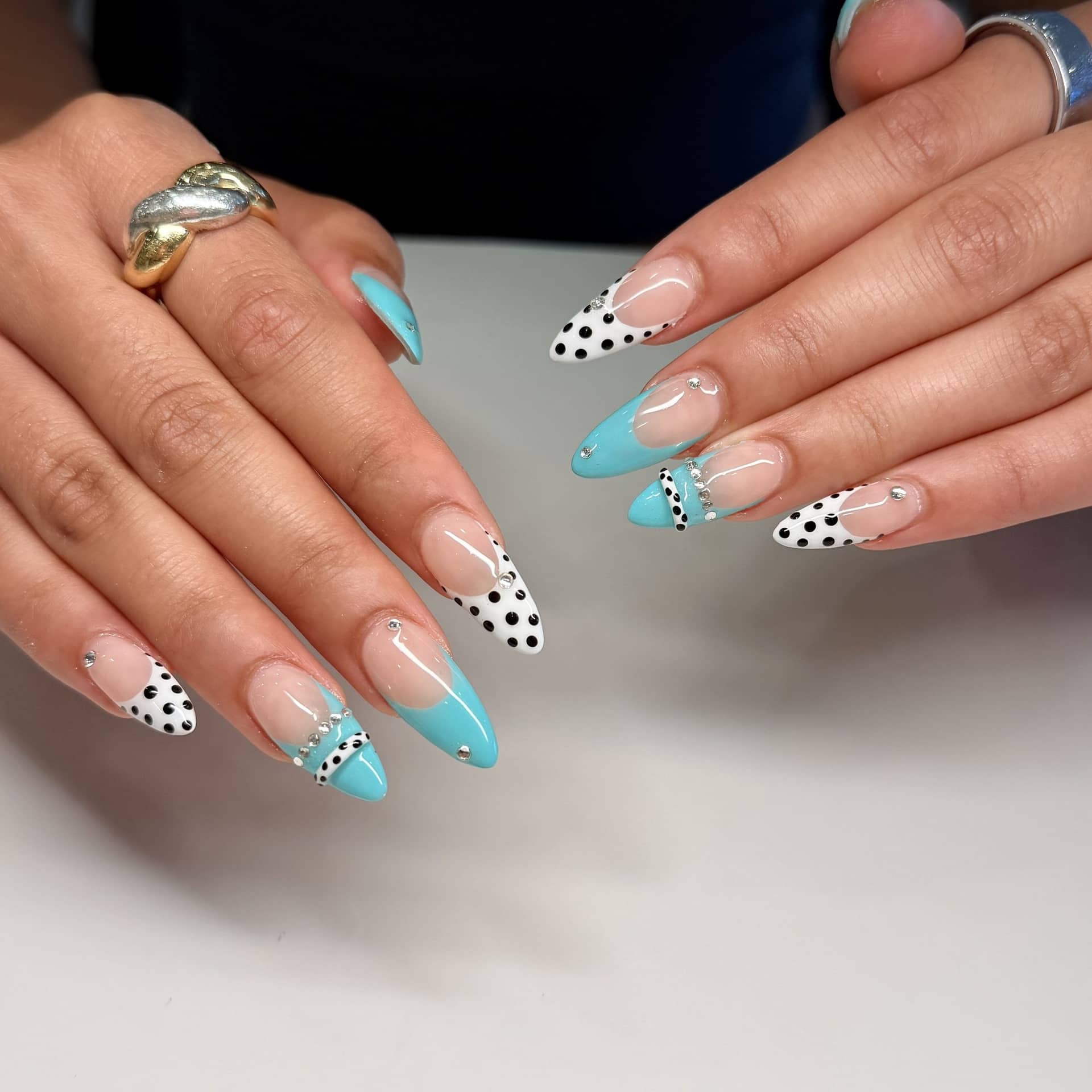 Turquoise and polka-dot French tips on long almond nails